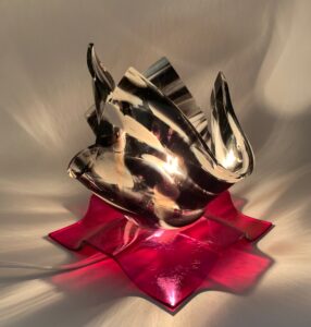 Zebra printed fused glass frilly lamp on a red glass base.