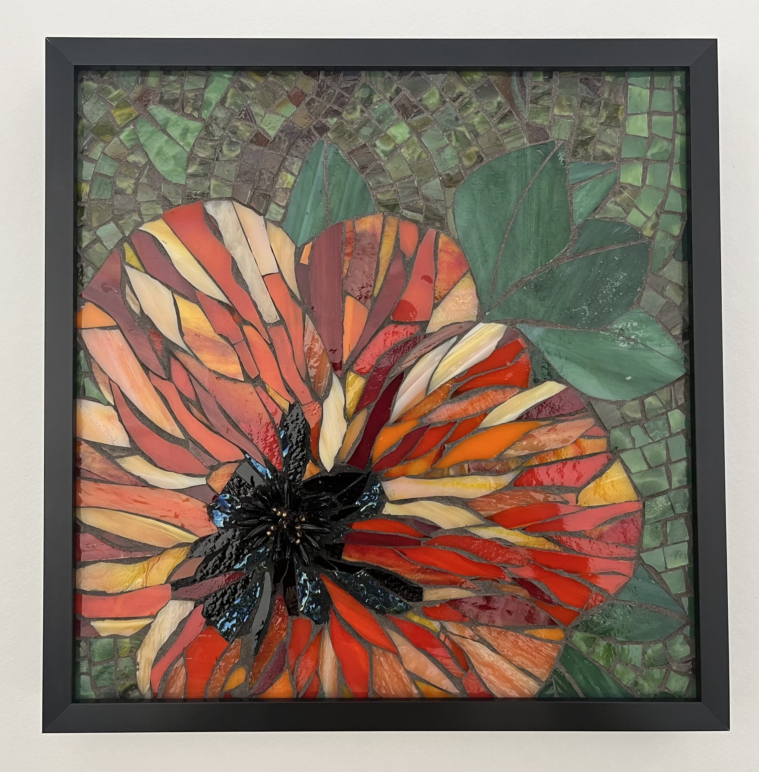 Stained glass mosaic of a poppy in red, with green leaves