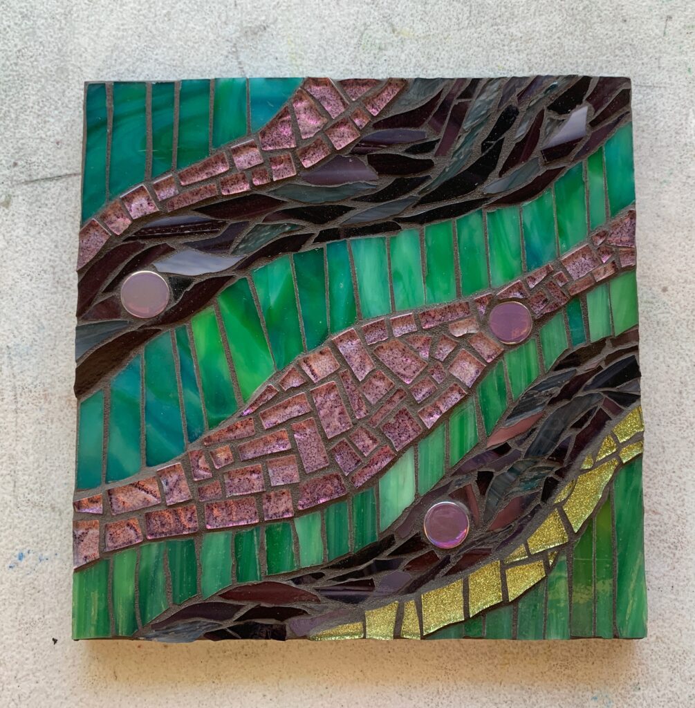 Purple and green stained glass mosaic by student, Claudia.